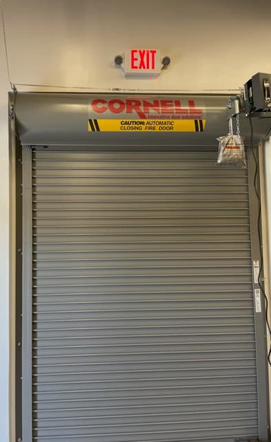 Technicians installing a fire rated door